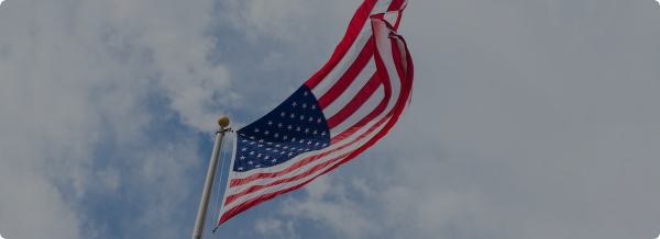 USA Flag flying in sky